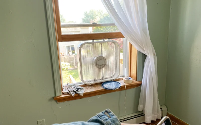 Box fan in an open window of a freshly painted Round Rock bedroom
