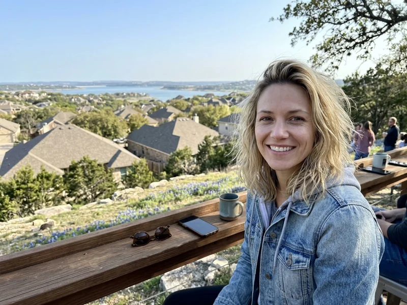 Williamson County neighborhood rooftops with live oaks and Round Rock in the distance