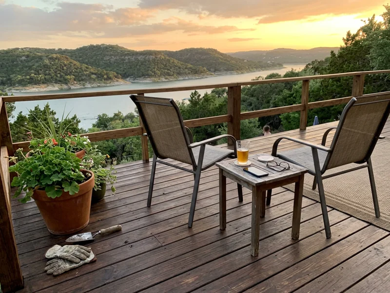 Freshly stained backyard deck with patio chairs overlooking the Sendero Springs greenbelt