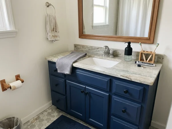Bathroom vanity painted navy with new hardware