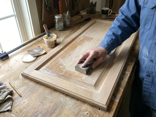 Applying grain filler to a honey-oak cabinet door