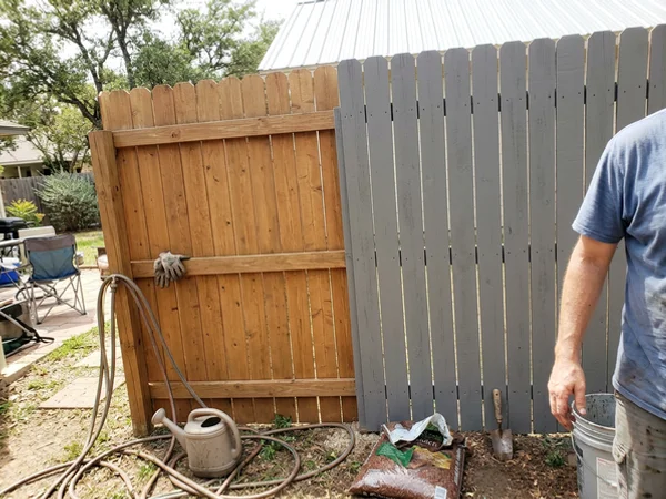 Semi-transparent and solid stain side by side on a Round Rock fence
