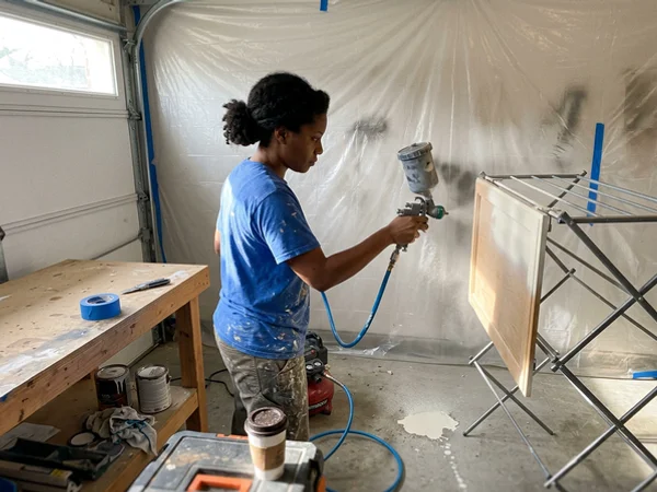 Spraying a cabinet door with an HVLP gun