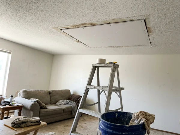 Water-damaged ceiling section replaced with new drywall